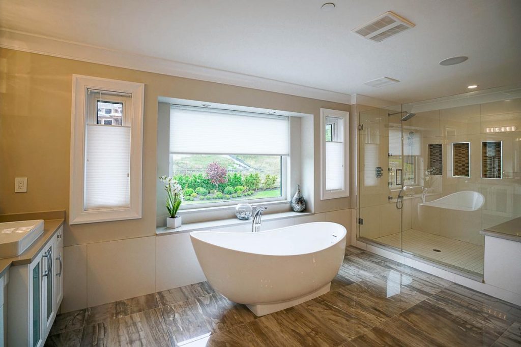bathroom renovation freestanding white tub wood gran porcelain tile custom glass shower gambrick custom home builders NJ