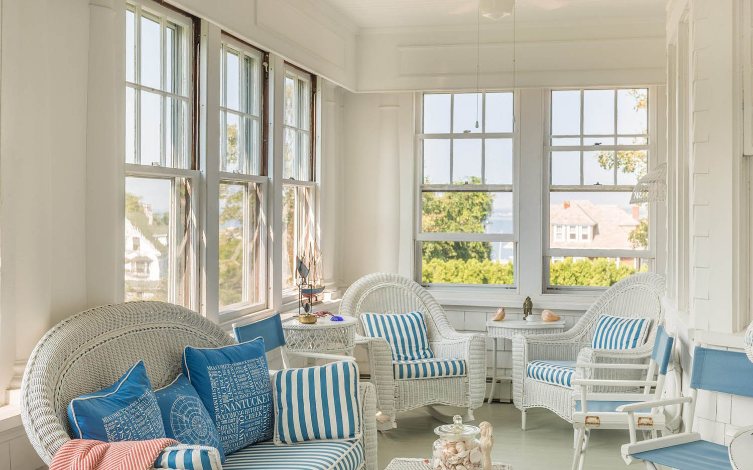 three season sunroom porch, white wicker chairs, blue cushions