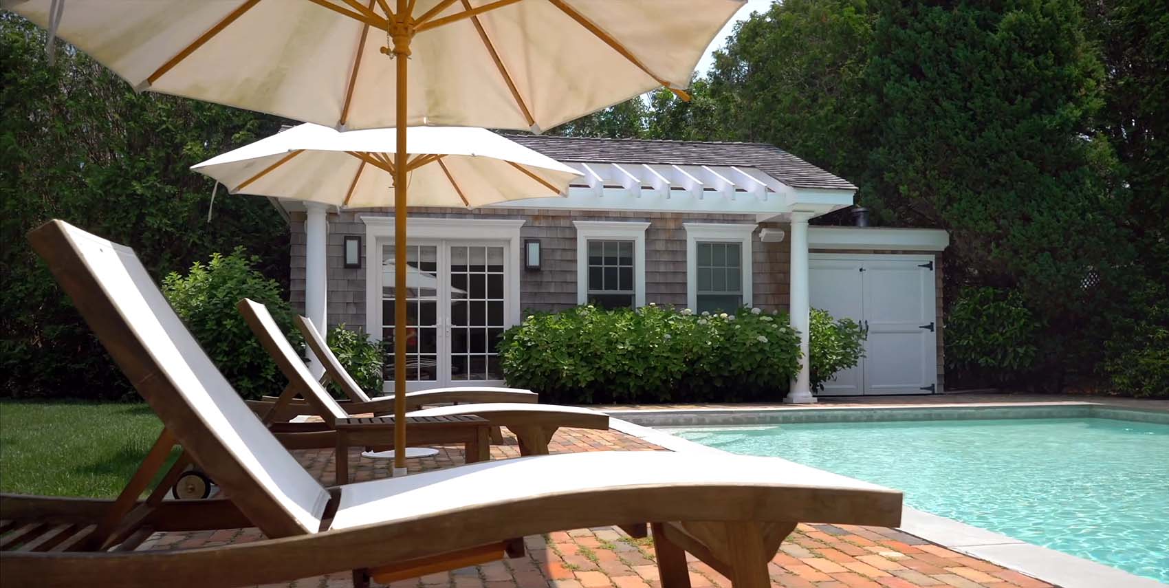 small NY pool house design cedar shingles white trim pergola