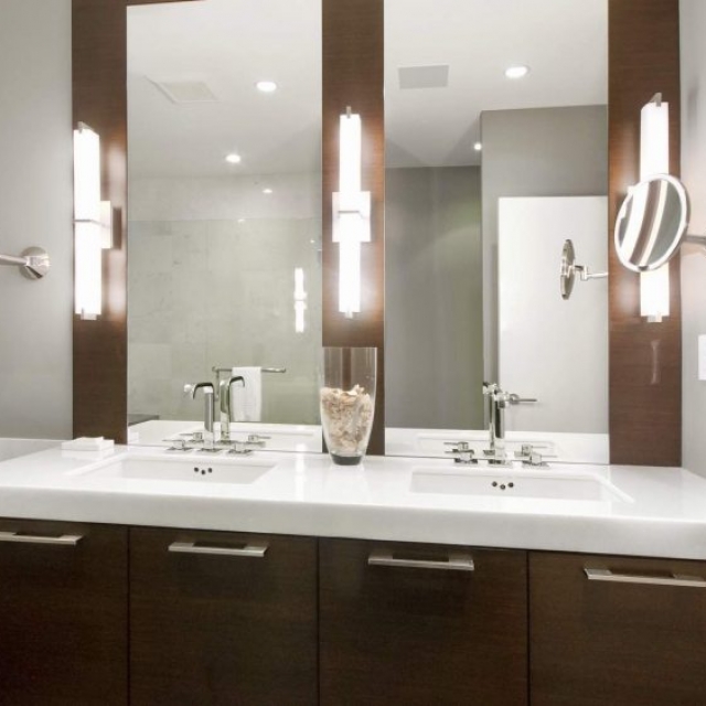modern double sinks, brown wood vanity with white granite top gray walls