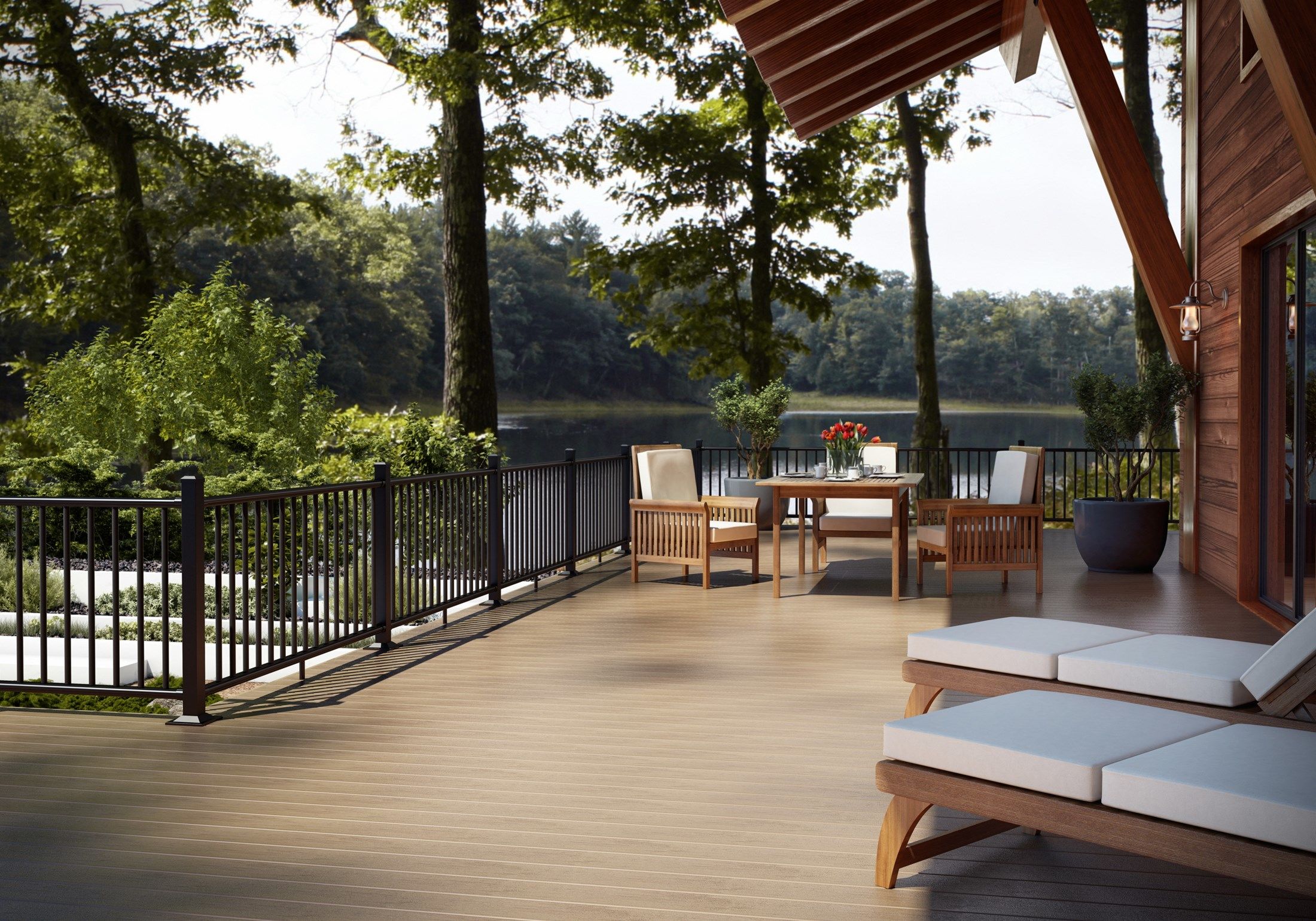 NJ lakefront Trex deck with black metal railings Wood patio furnite white cushions