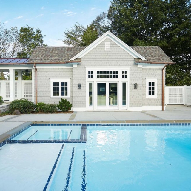 custom home builder NJ pool house with covered walkway and in ground pool