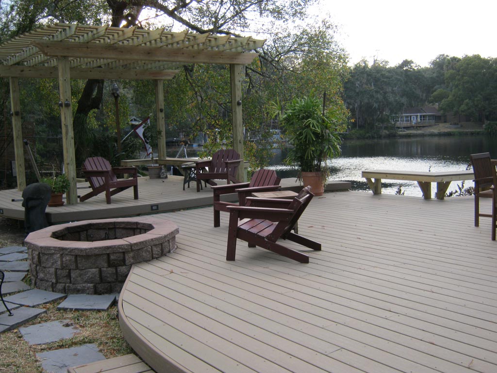 NJ Shore custom Lakefront Trex deck with curved design, Wood arbor, wood furniture, built in benches
