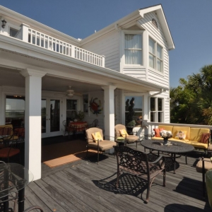 Monmouth County NJ Custom wood deck with white railings, colorful pillows, covered porch