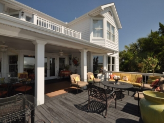 Monmouth County NJ Custom wood deck with white railings, colorful pillows, covered porch