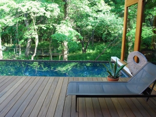 NJ deck company Ipe poolside deck, modern rectangle pool with travertine bullnose, contemporary home