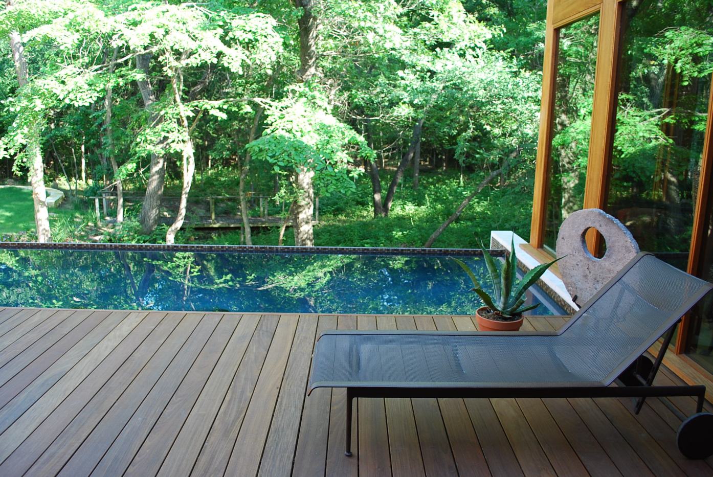 NJ deck company Ipe poolside deck, modern rectangle pool with travertine bullnose, contemporary home
