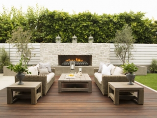 Modern NJ Ipe deck design with wood furniture, real white brick outdoor fireplace, wicker furniture
