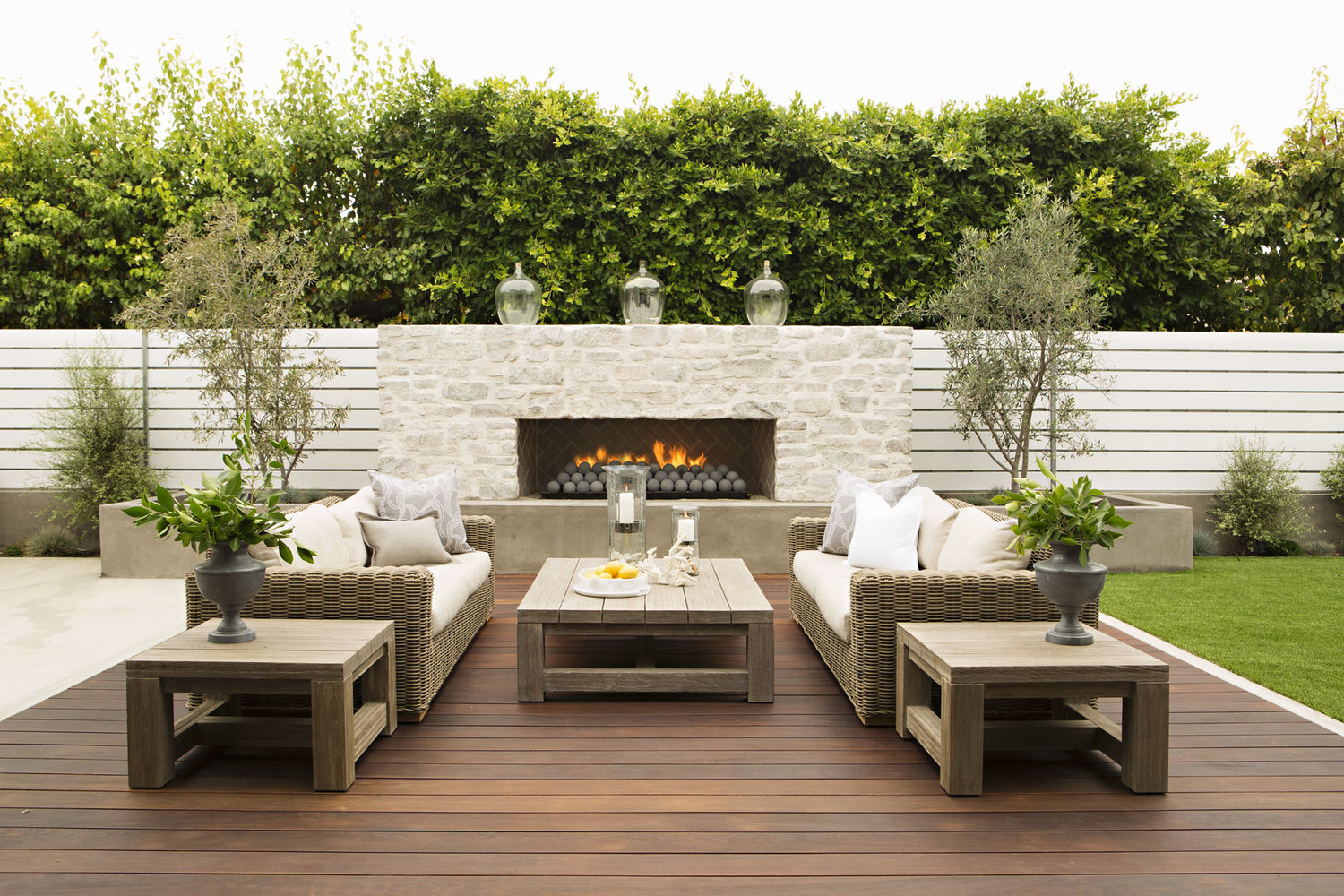 Modern NJ Ipe deck design with wood furniture, real white brick outdoor fireplace, wicker furniture