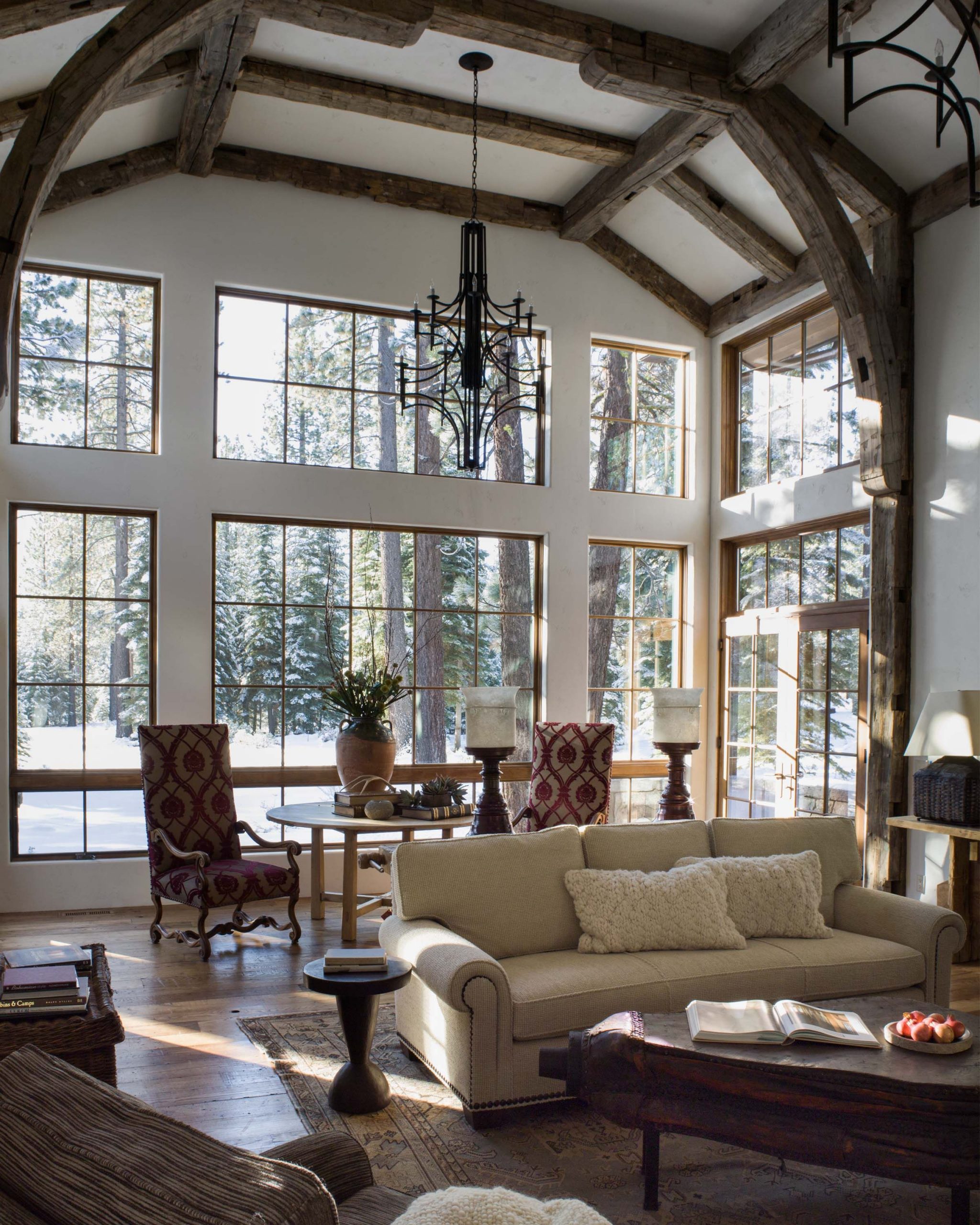sunroom with glass walls and reclaimed timber beams