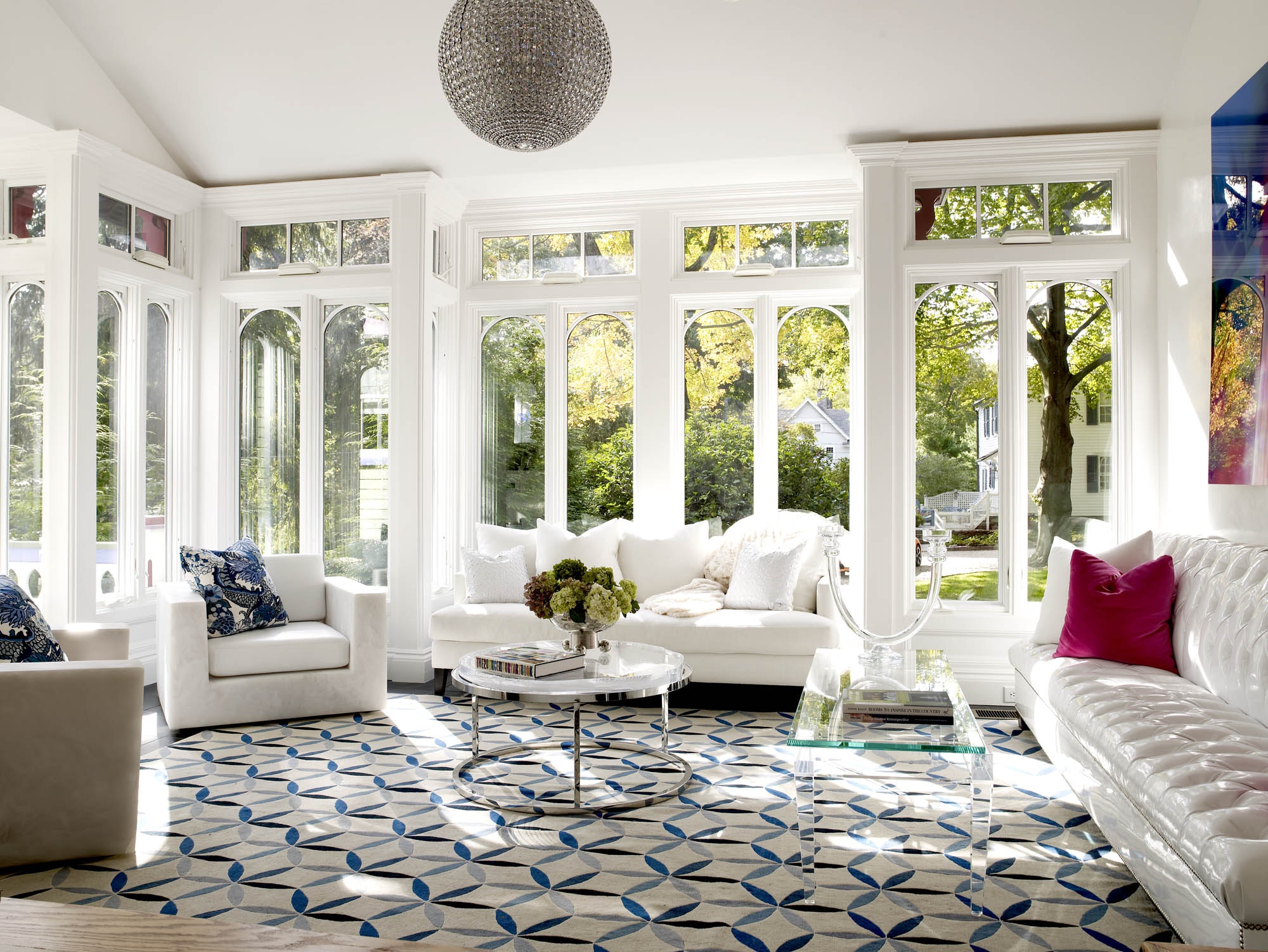 sunroom with a funky fun design disco ball glass tables and white furniture colorful accents