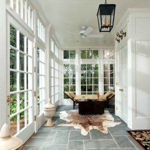 beautiful bright white sunroom with glass walls porcelain grey tile floors bead board NJ custom sunroom builder