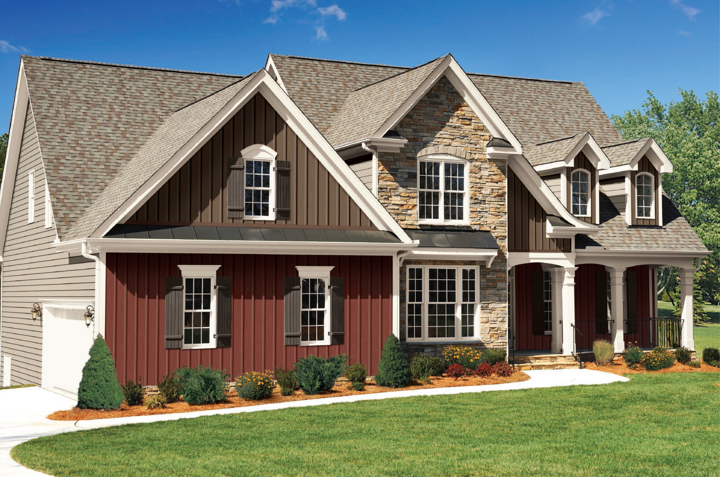 Red and brown two toned vertical siding colors with brown roofing shingles and black metal accents. White trim and columns with black metal railings. Brown stone veneer.