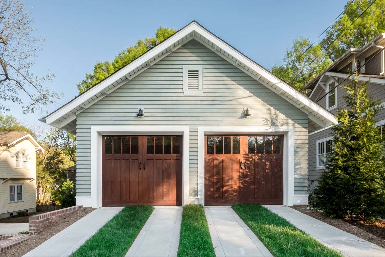 detached garage with grass and concrete driveway real wood garage doors