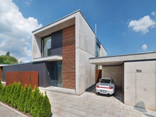 One car detached garage with contemporary style. Concrete walls with a paver floor. Flat roof.
