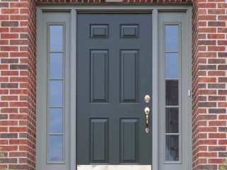 gray front door with side transoms light gray trim red brick house