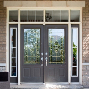 Dark gray french front door with glass stransoms and beige brick house