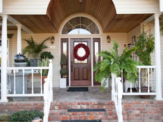 stained wood front door with glass transoms wood soffet red brick front porch house