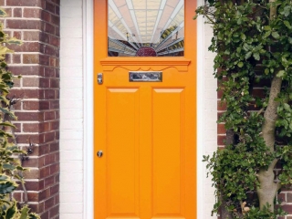 orange front door with white trim on red brick house beautiful porch plants craftsman style door glass