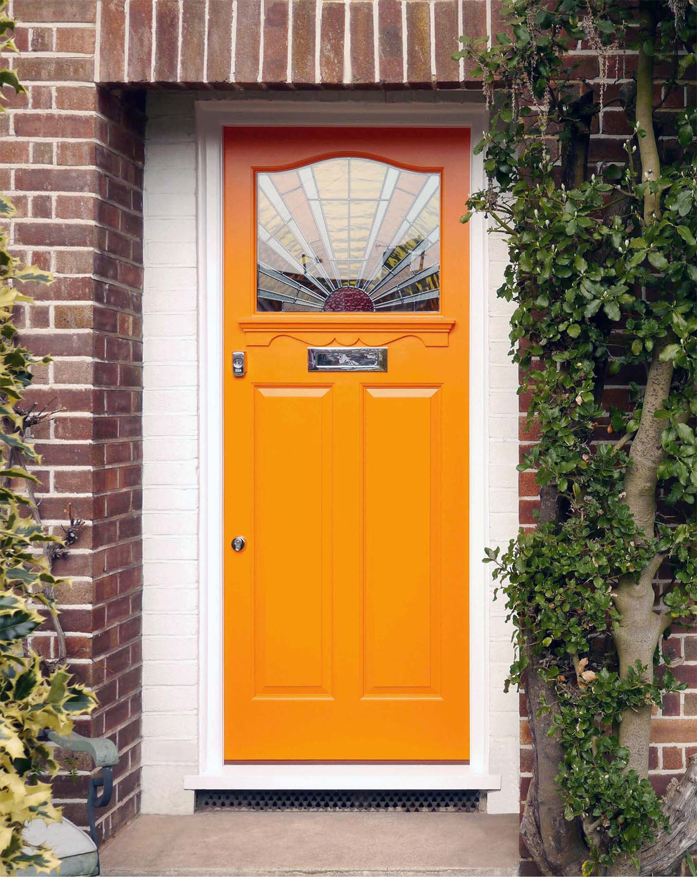 orange front door with white trim on red brick house beautiful porch plants craftsman style door glass