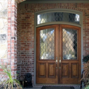 real wood front door with arched top and transom french style red brick house with real stone
