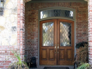 real wood front door with arched top and transom french style red brick house with real stone