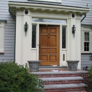 real wood front door with transoms and cream trim red brick stoop and limestone