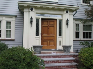real wood front door with transoms and cream trim red brick stoop and limestone