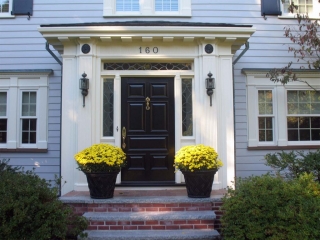 Black front door with transoms red brick stoop with limestone