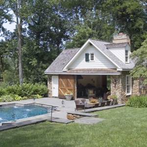 cute country pool house real stone with white siding real wood doors blue stone patio