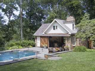 cute country pool house real stone with white siding real wood doors blue stone patio