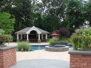 pool house design with huge patio pavers and blue stone brick pillars in ground pool real stone