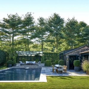 rustic pool house design in gound rectangle concrete pool with blue stone patio real stone seating area