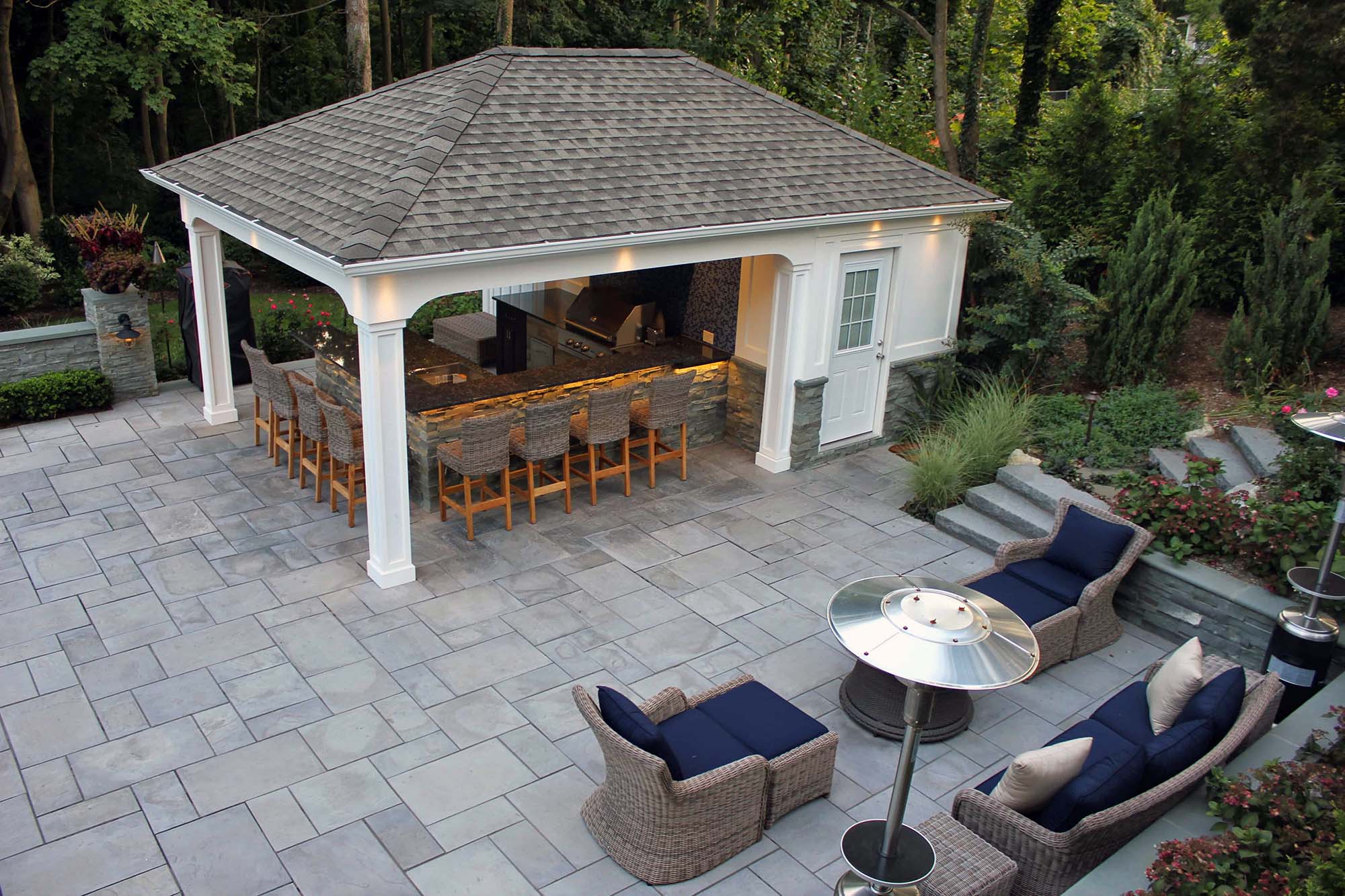 cute pool house with outdoor kitchen stamped concrete patio white columns