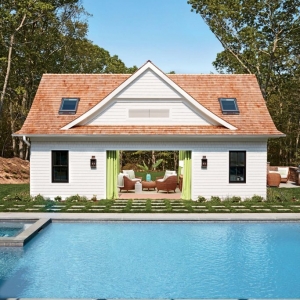 cute pool house design open french doors white siding green curtains stone tile