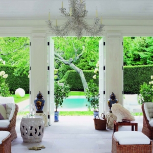 pool house interior french doors stone floors light and bright wicker furniture white cushions