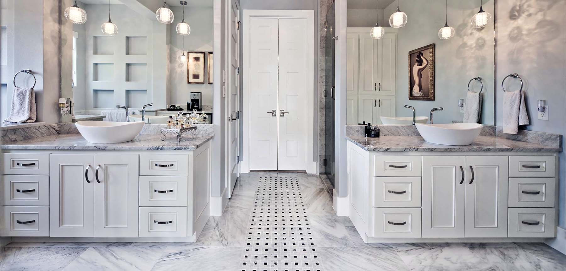 luxury master bathroom double white shaker cabinets with marble floors