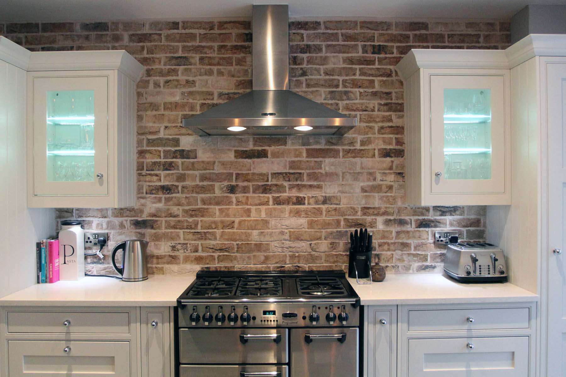 red brick backsplash kitchen cabinets white with white countertops stainless steel appliances