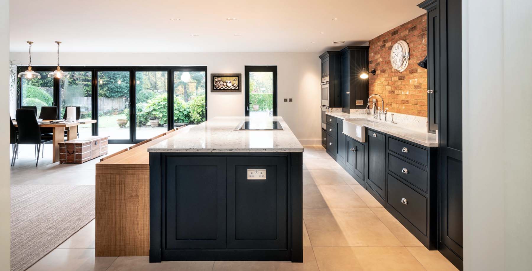 kitchen design with black cabinets white countertops red brick backsplash