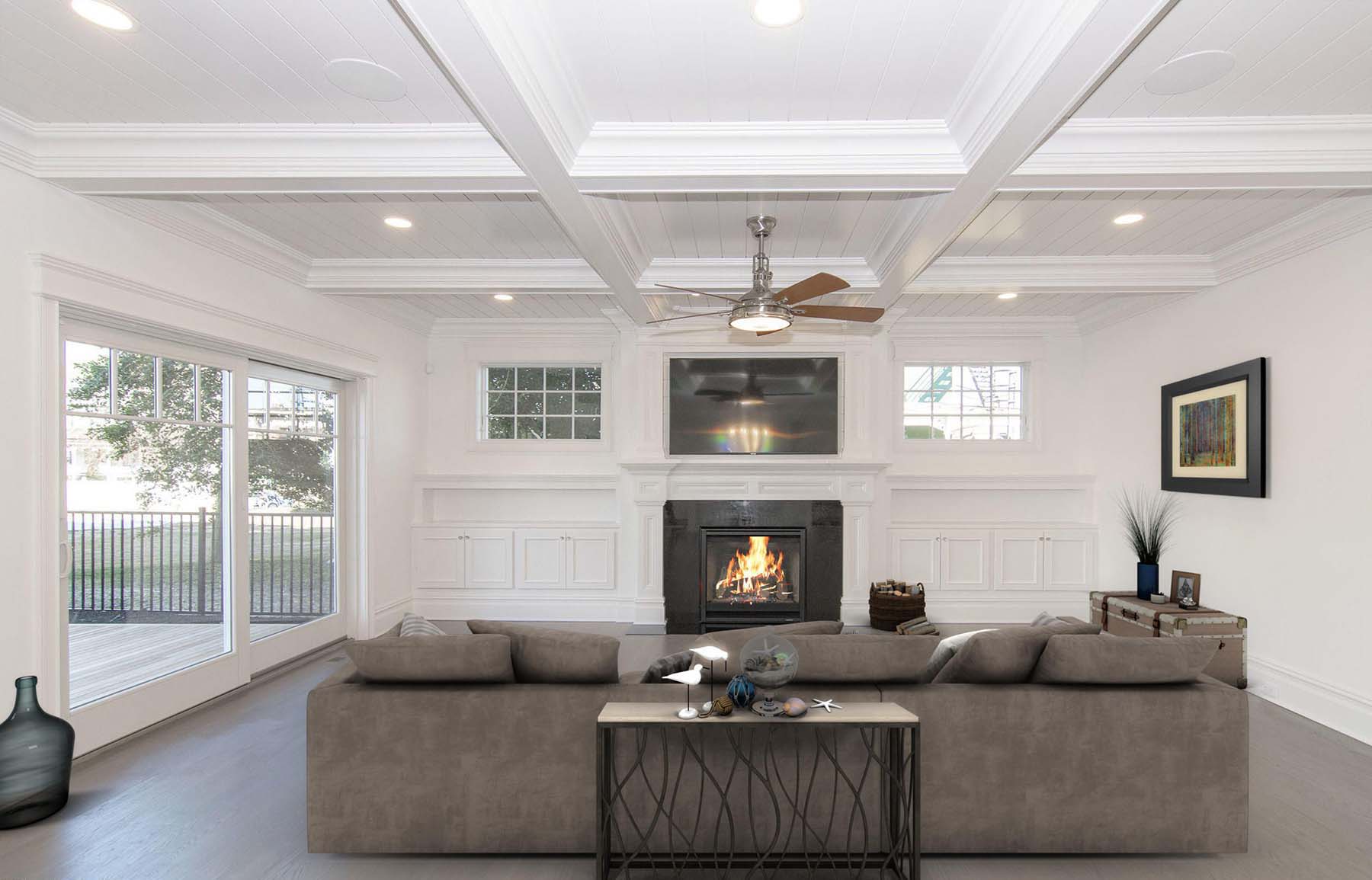 Living room with white walls and white coffered ceiling with bead board coffers and built ins.