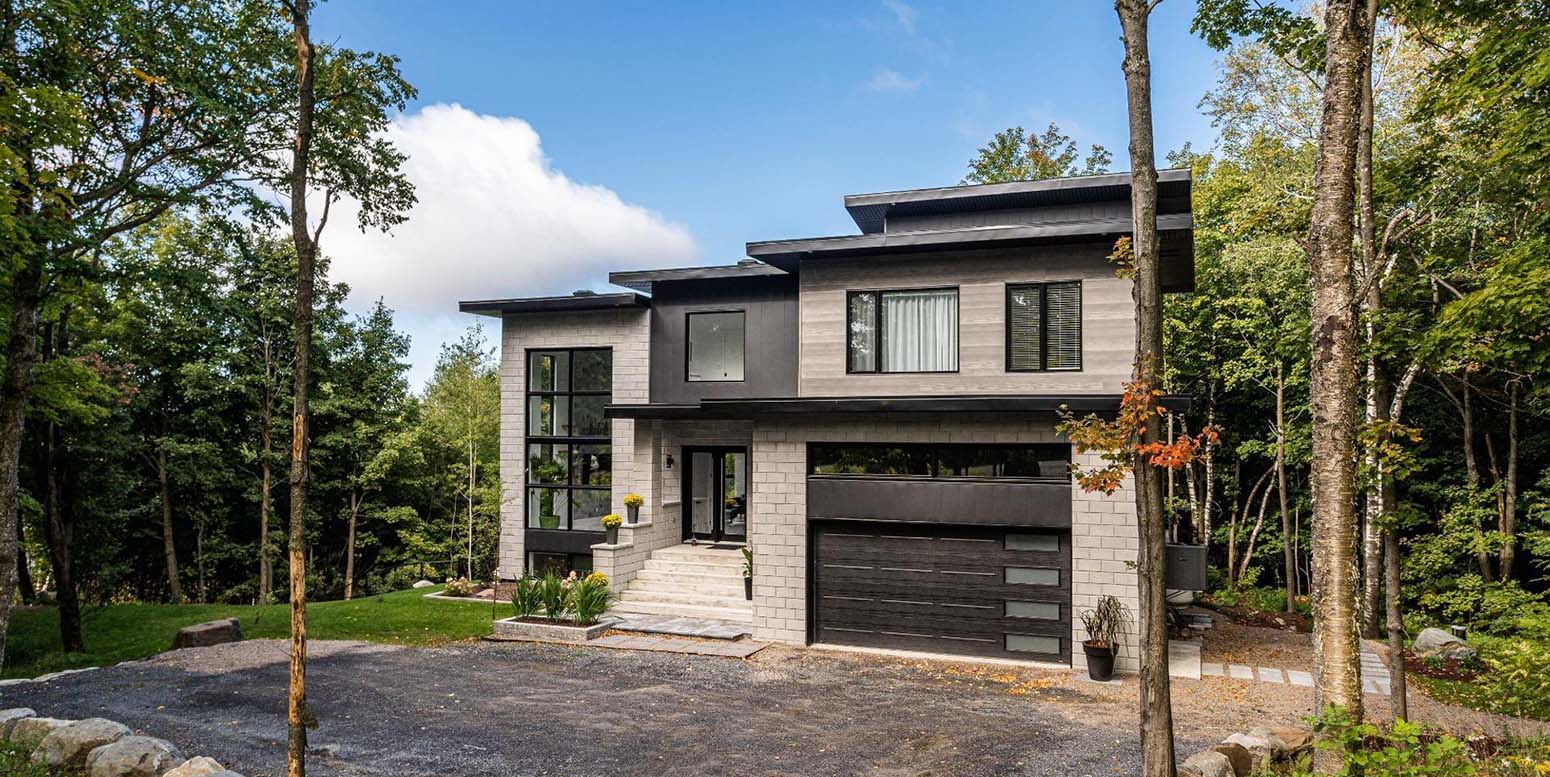 all black and grey house with modern style black garage doors