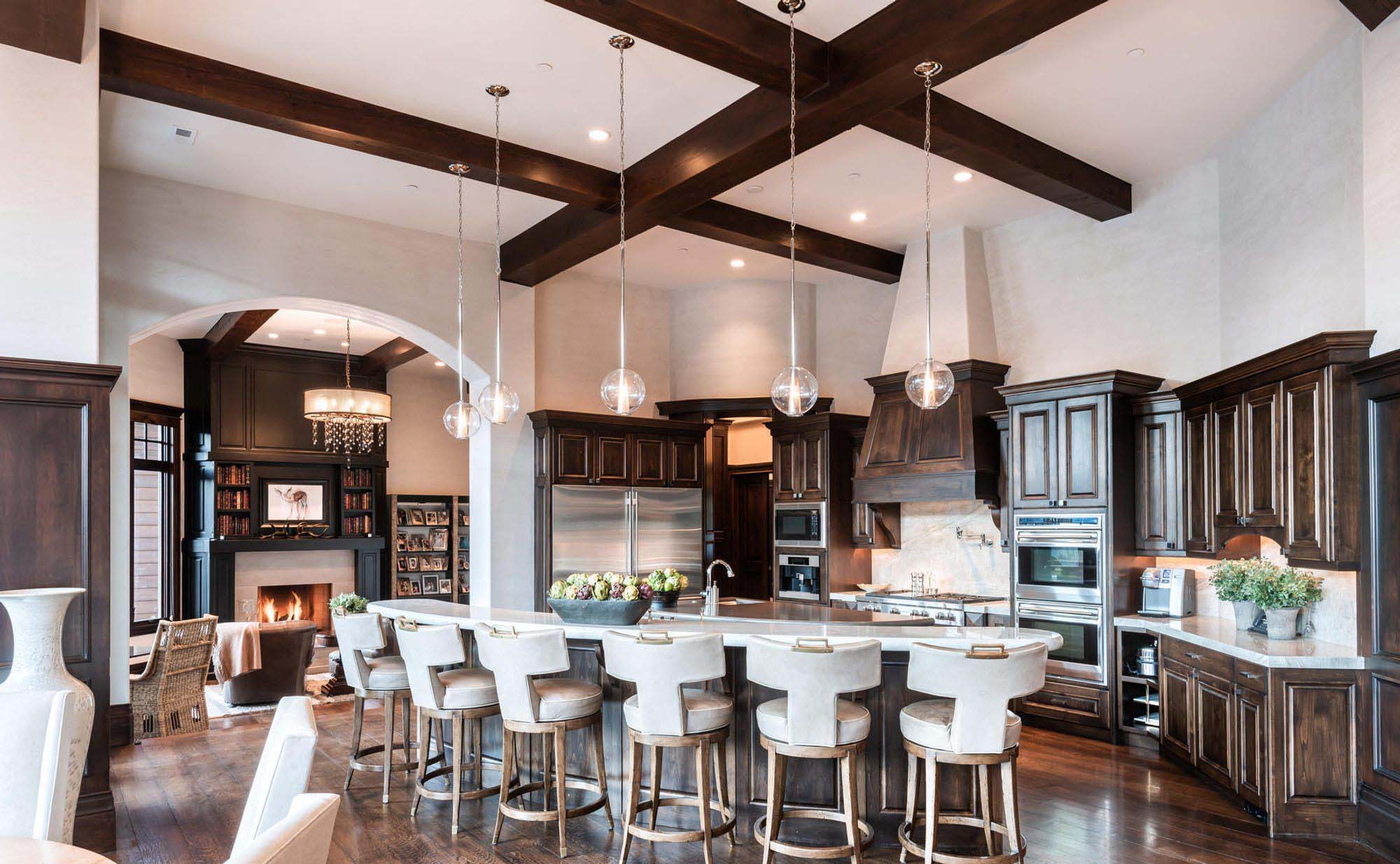 Luxury high end kitchen with dark wood floors, cabinets and coffered ceiling with exposed real wood beams.