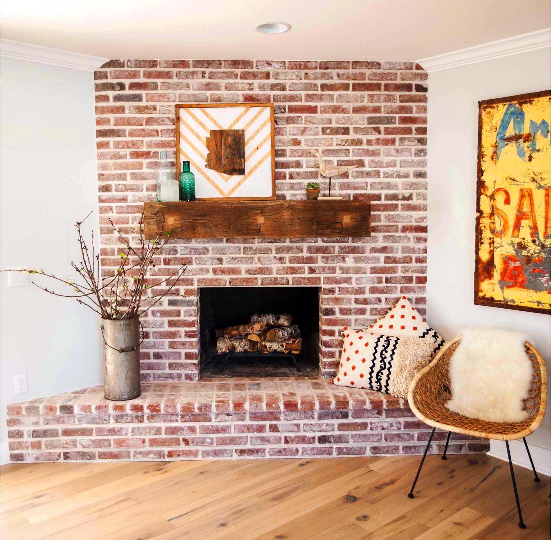 red brick living room fireplace with large timber real wood shelf