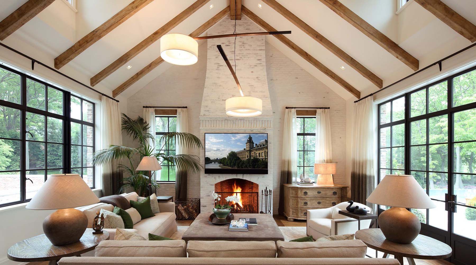 white washed living room fireplace with vaulted ceilings and exposed real wood beams