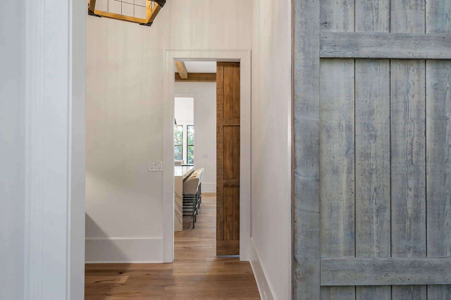 Aged gray wood barn doors with a vintage style. Closeup view of the front and back side.