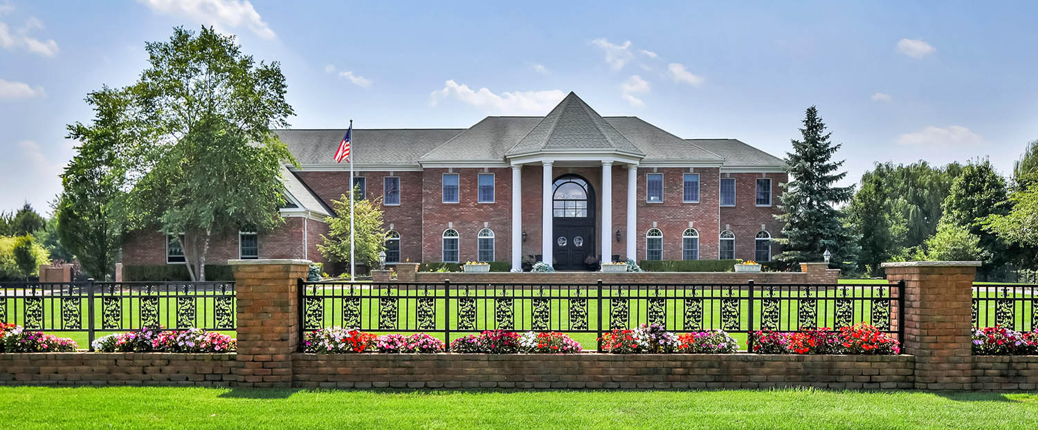 Red brick estate home with huge front columns.