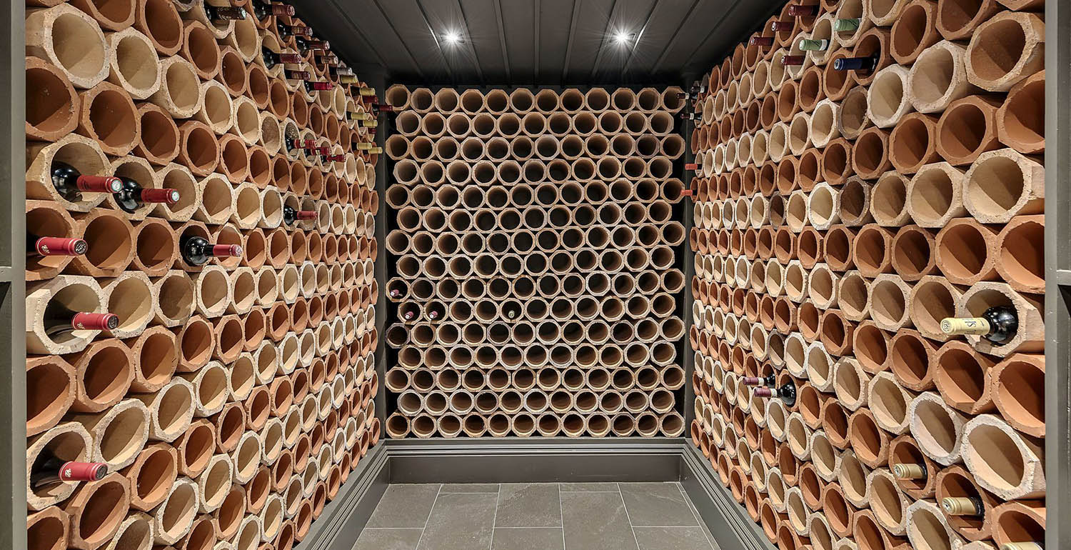 Contemporary wine cellar design. Single bottle tube wine racks.