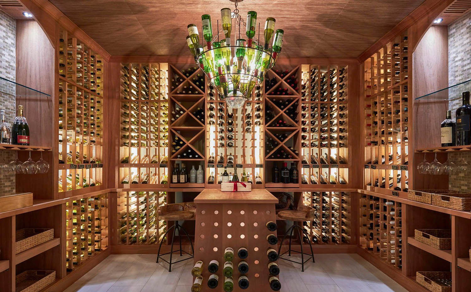 large wine room with wood racks and custom wine bottle chandelier. 