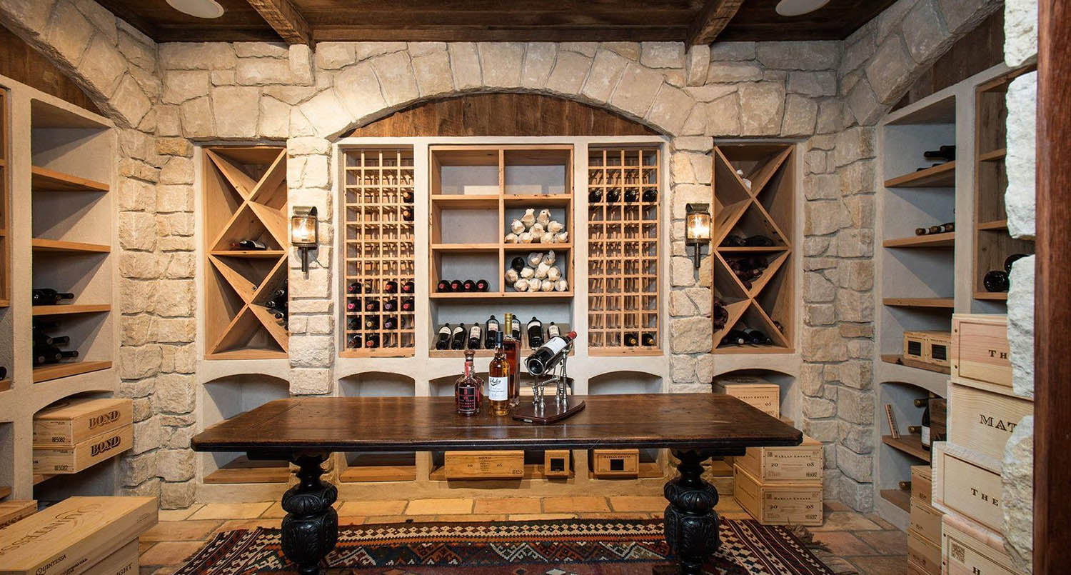 wine cellar design ideas stone walls with wood shelves and center table