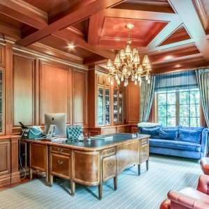 Home office with wood wall paneling and beautiful all wood coffered ceiling with center diamond design.
